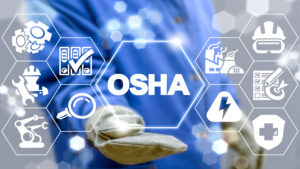 Image of a man's hand with a digital overlay of the acronym OSHA and safety hazard symbols.